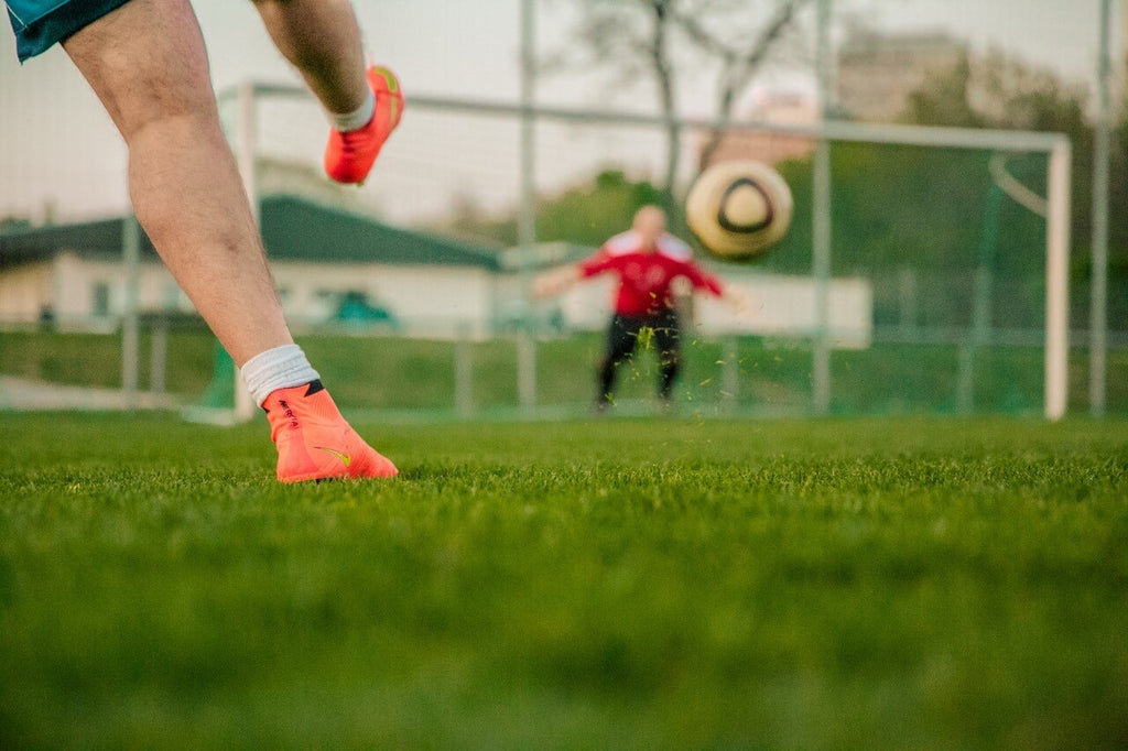 Football shooting on football goal with goalkeeper